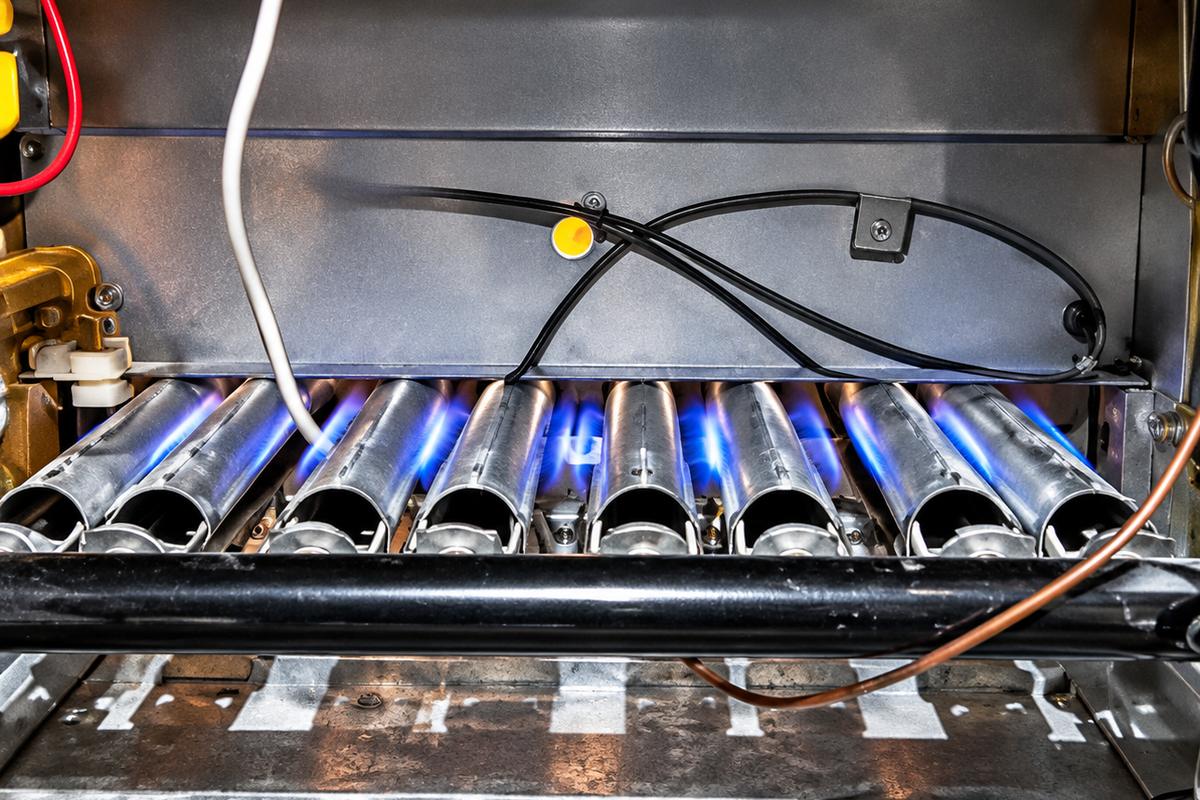 Blue flames on the burners of a gas furnace